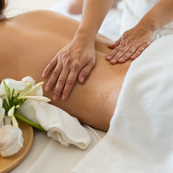 Young beautiful Asian woman sleep relaxing in the Oil spa massage in salon. Select focus hand of masseuse